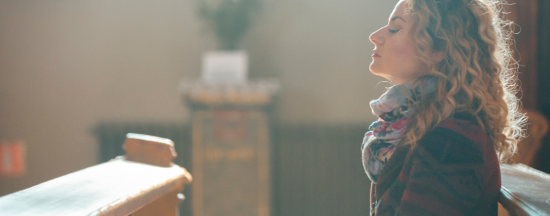 Person in church pew during church search looking for healthy church green flags