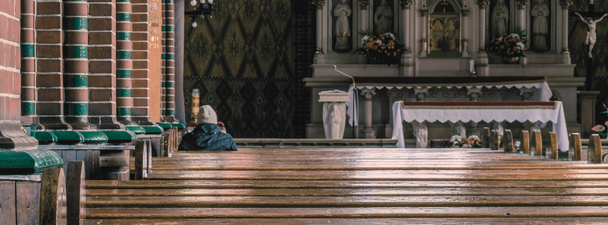 Person sitting in empty church pew contemplating when to leave a church