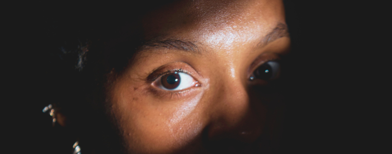 Christian woman struggling with anxiety in church wondering is anxiety a sin?