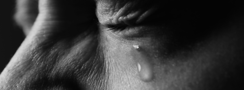 Woman sitting alone in grief, illustrating Romans 8:28 and the misuse of "all things work together for good" in fresh tragedy