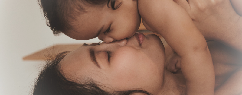 Postpartum depression and faith - a mother holding her baby while struggling with PPD