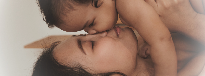 Postpartum depression and faith - a mother holding her baby while struggling with PPD
