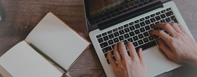Woman sitting at desk writing about spiritual gifts